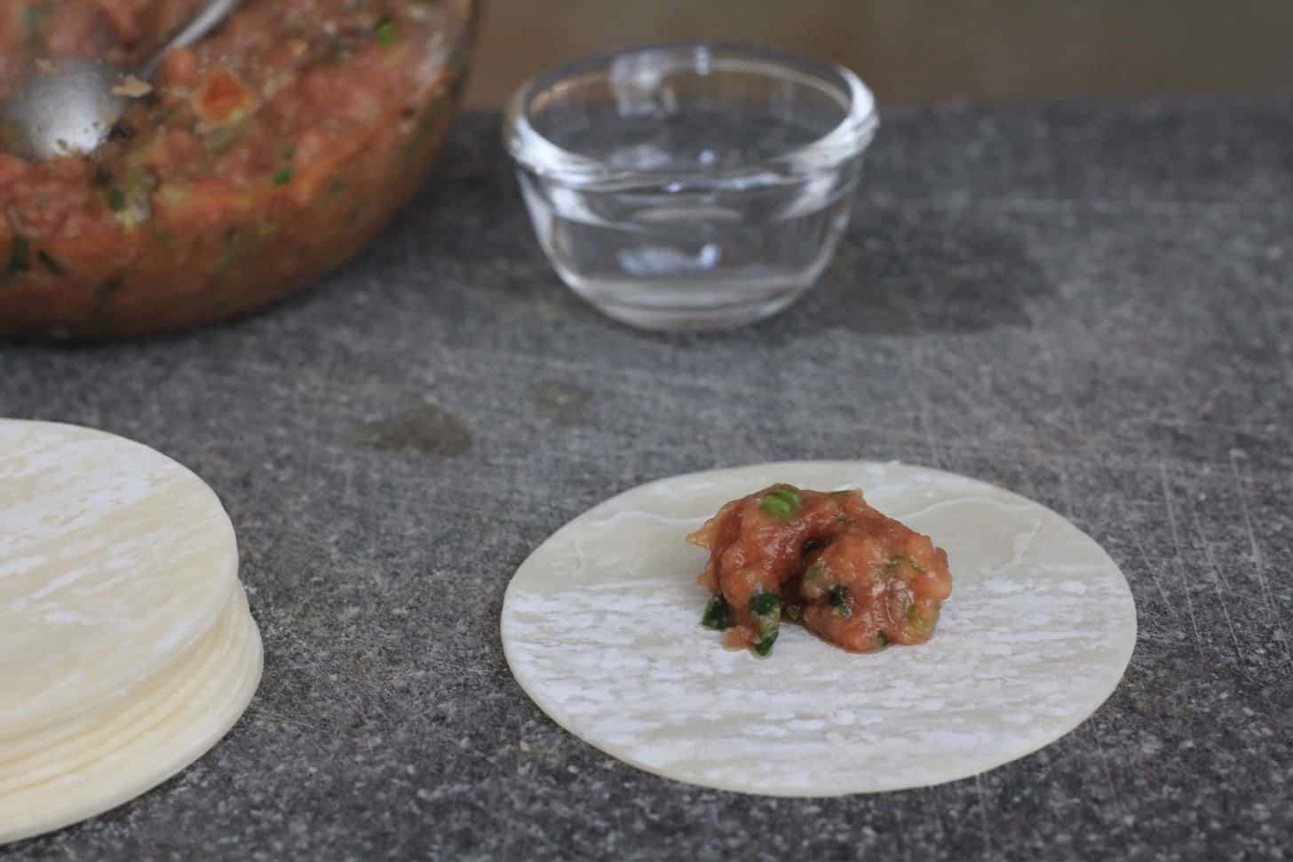 filling gyoza wrappers with pork