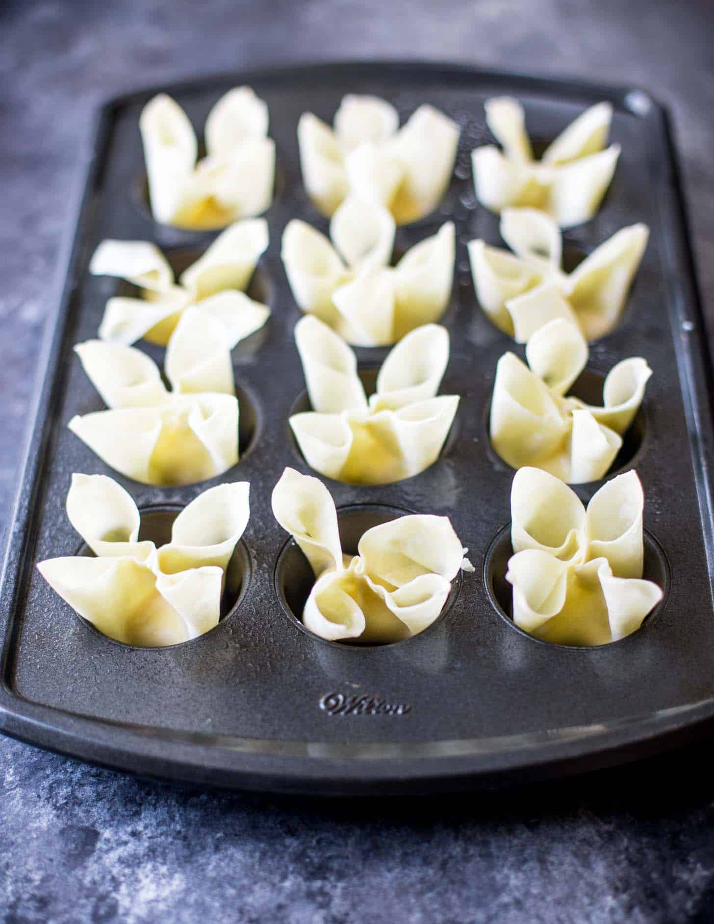 uncooked rangoon in a muffin tin