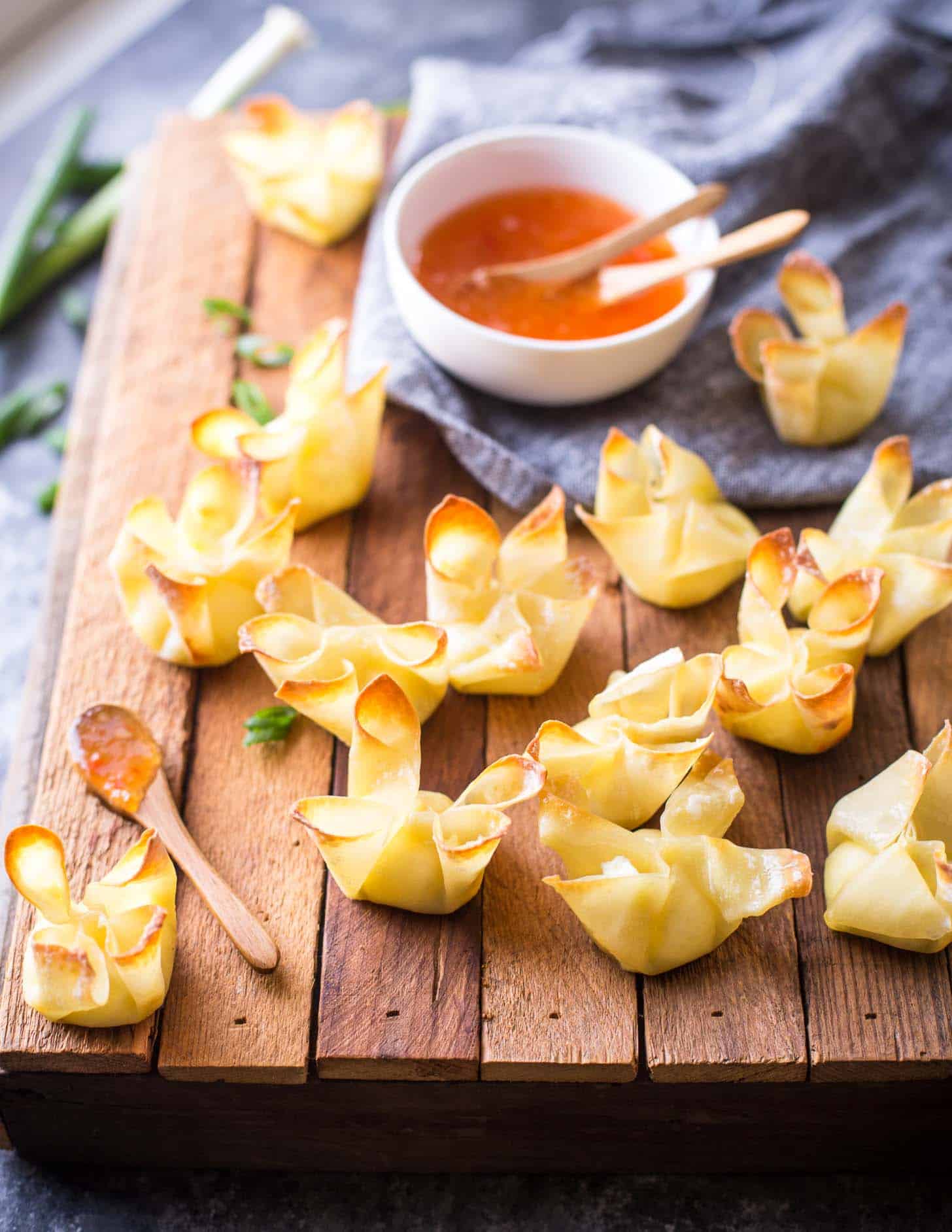 baked crab rangoon on a wooden tray