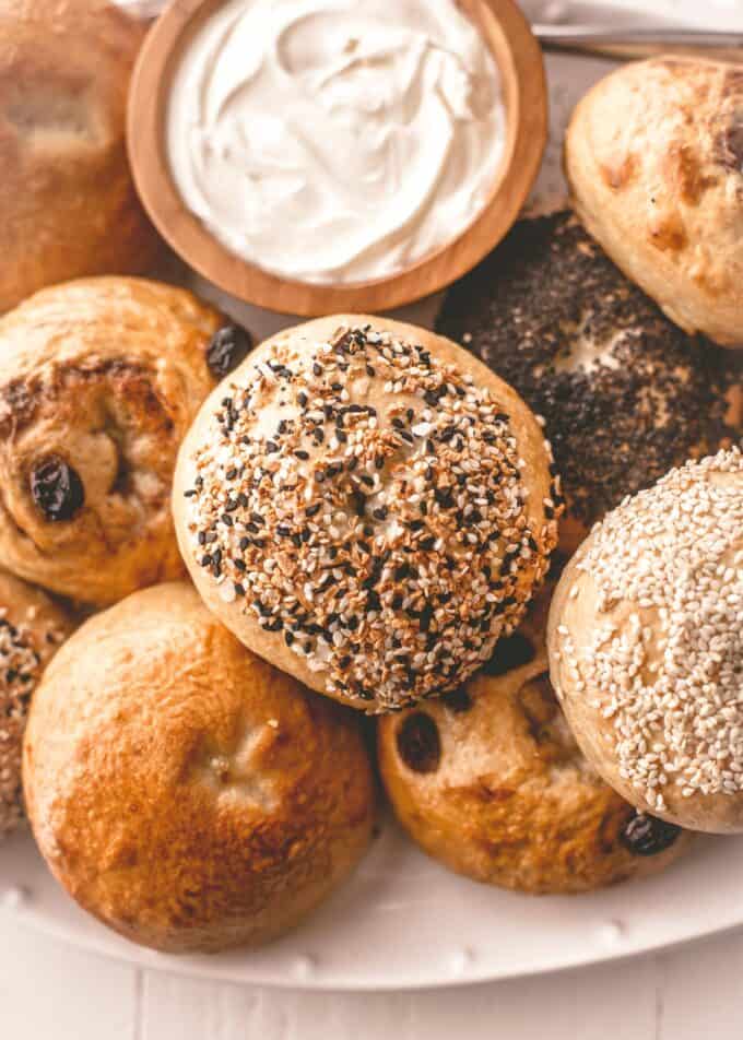 homemade bagels on a wooden board with cream cheese