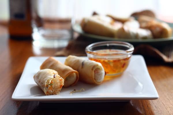 spring rolls and dipping sauce on a square white plate