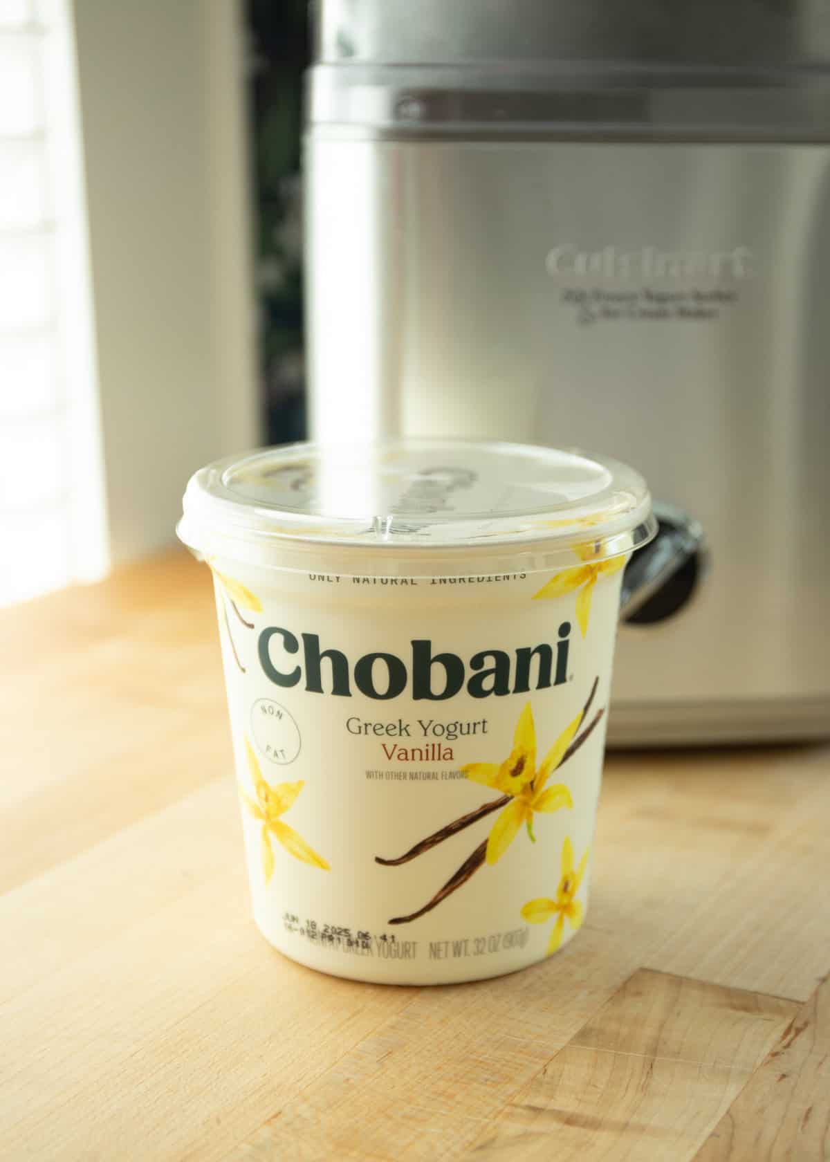 a container of French vanilla Greek yogurt on a white countertop