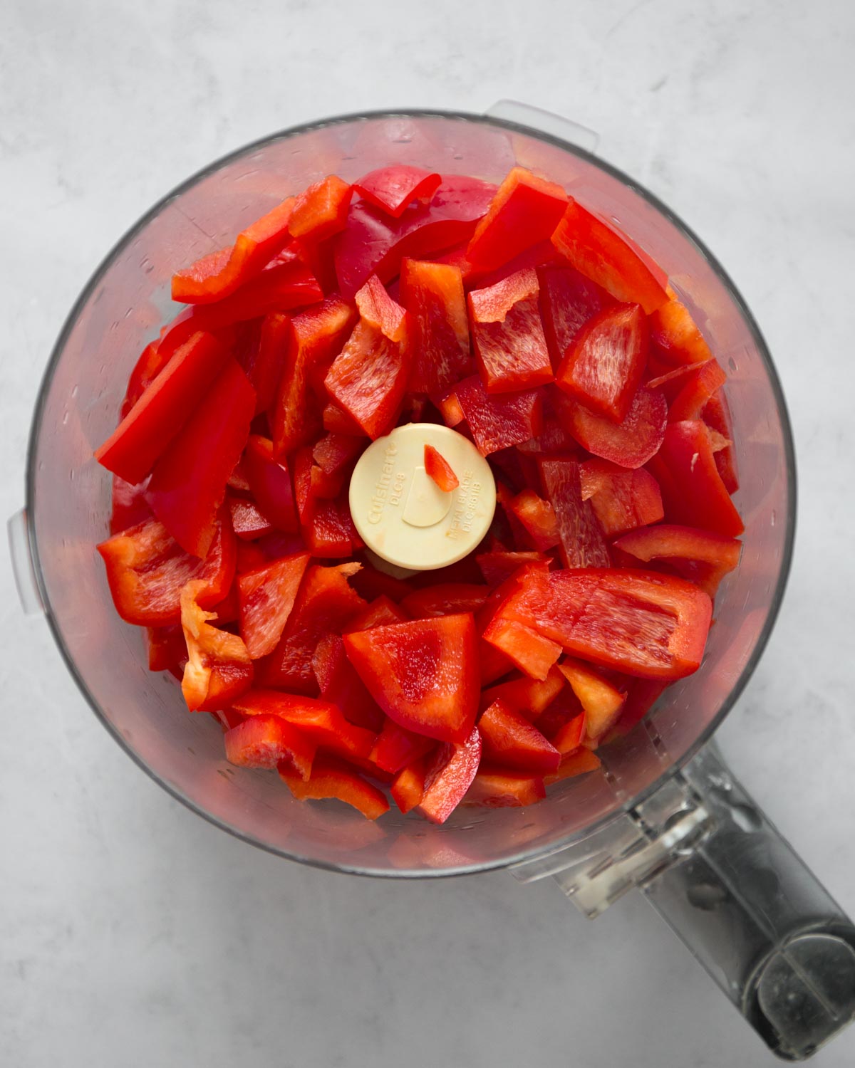 pieces of red bell pepper in a food processor