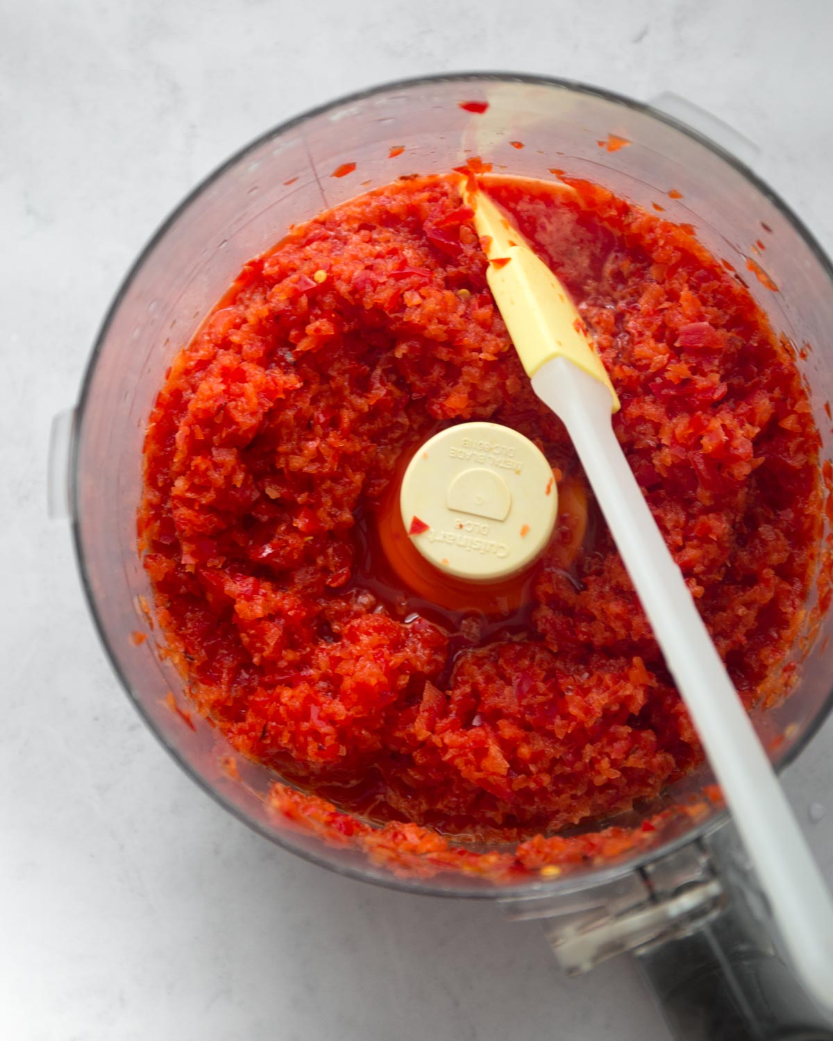 overhead image of red pepper puree in a food processor