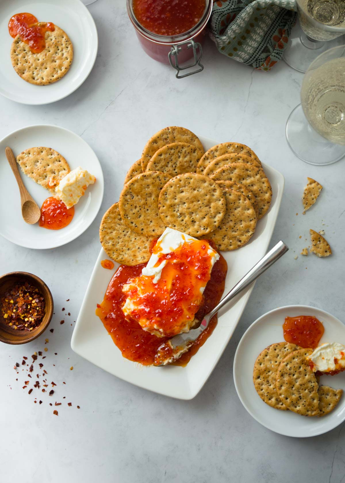 jelly, cream cheese and crackers on a white tray