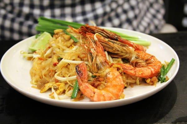 a side few of pad thai with shrimp in a white bowl