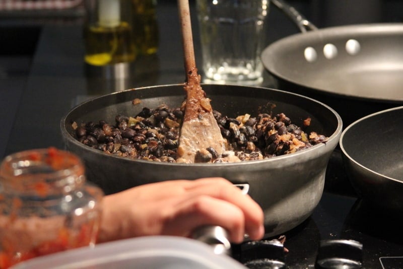 cooking black beans in a large skillet