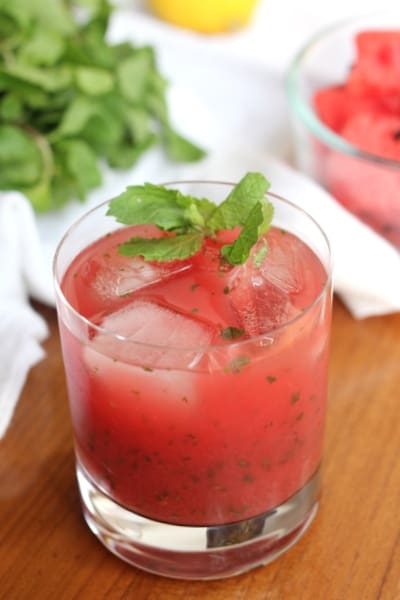 a glass of watermelon mint lemonade on a wooden table