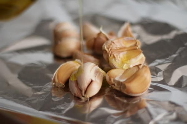 garlic cloves on a sheet of aluminum foil