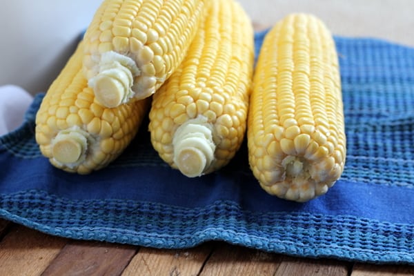corn on the cob resting on a blue dish towel