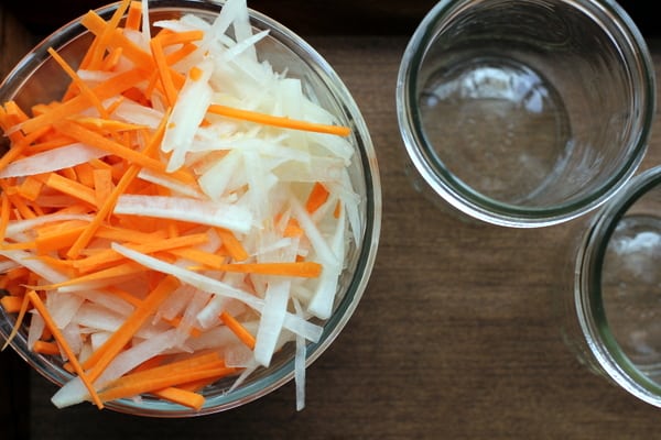 carrot and daikon strips in a glass bowl