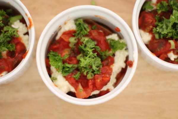 small white ramekins of lasagna with parsley on top