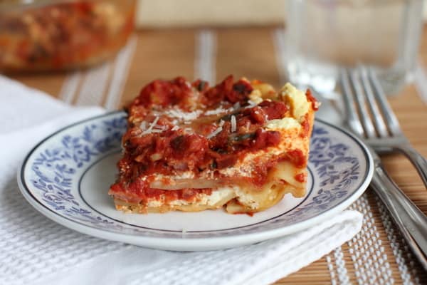 a piece of lasagna on a blue and white plate