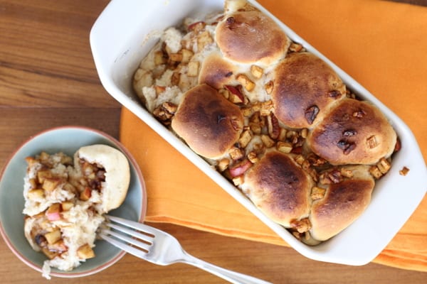 Apple cinnamon bread in pan with a portion on the table