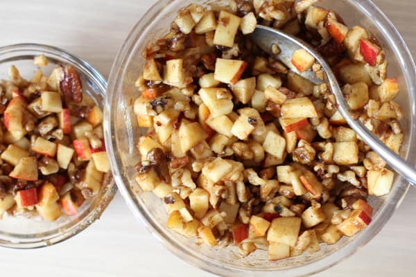 Mixing apples, cinnamon and nuts in a bowl