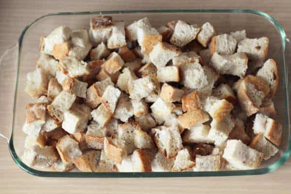 bread cubes in a large clear glass baking dish