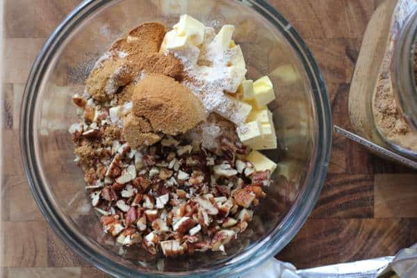 mixing pecan topping in a clear glass bowl