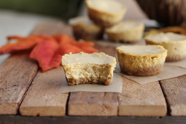 Pumpkin Cheesecake Bites on a wooden tray