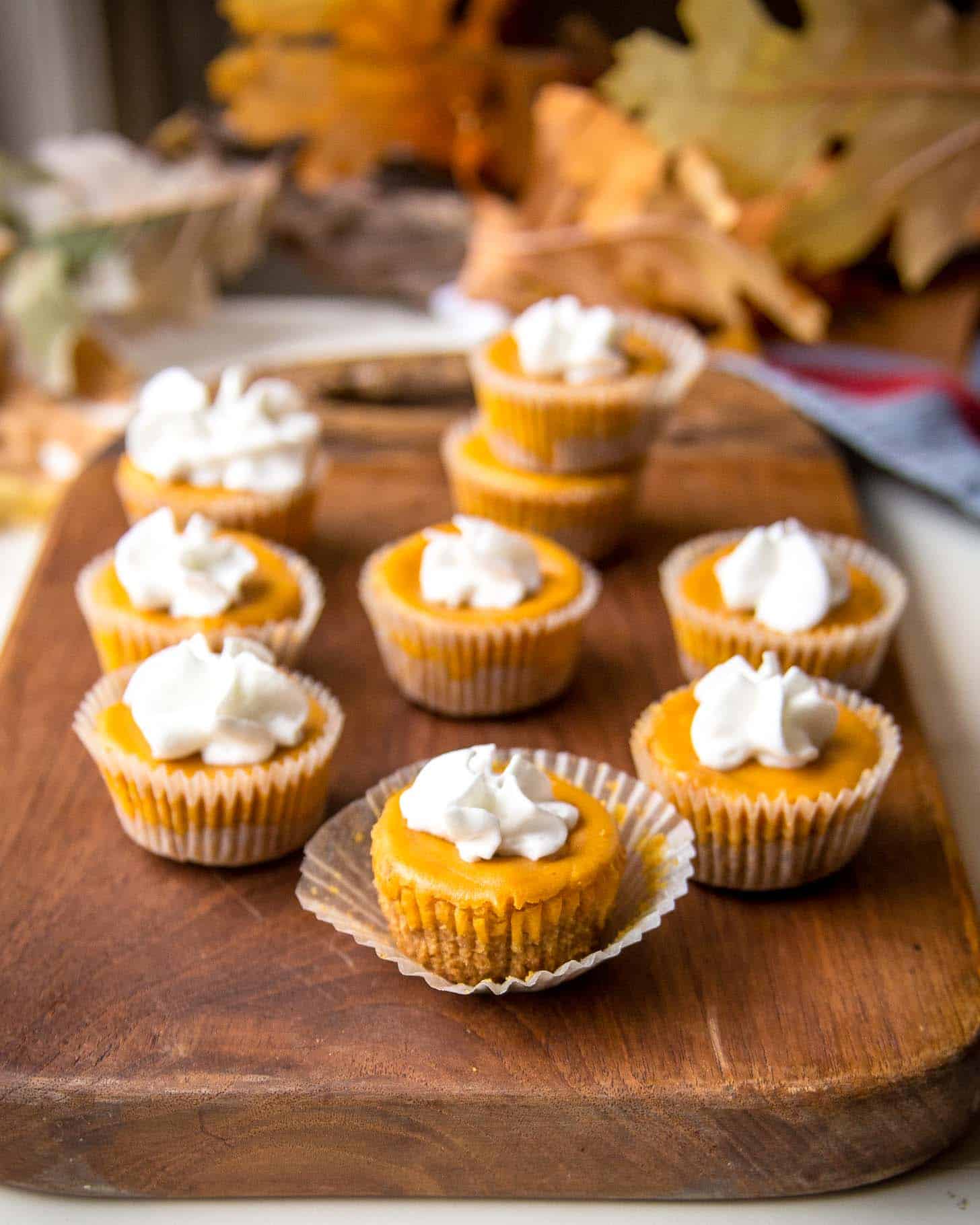 Pumpkin Cheesecake Bites on a wooden tray