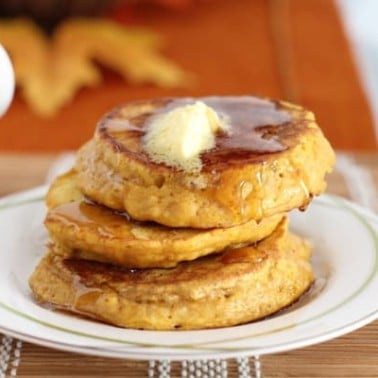 a stack of pumpkin pancakes on a white plate