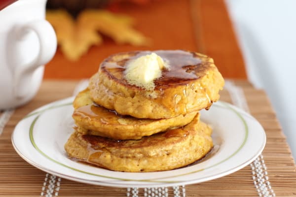 a stack of pancakes on a white plate