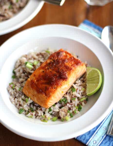 overhead image of salmon and rice in a white bowl