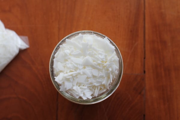 soy wax flakes in a clear glass bowl