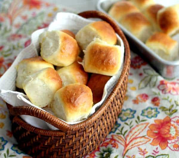 dinner rolls in a towel lined basket