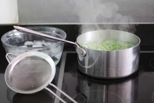 cooking beans in a saucepan on a stovetop