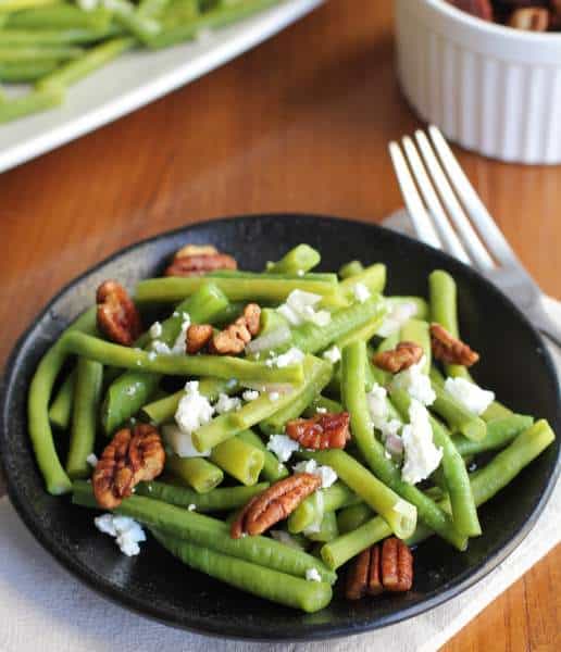 green beans on a black plate