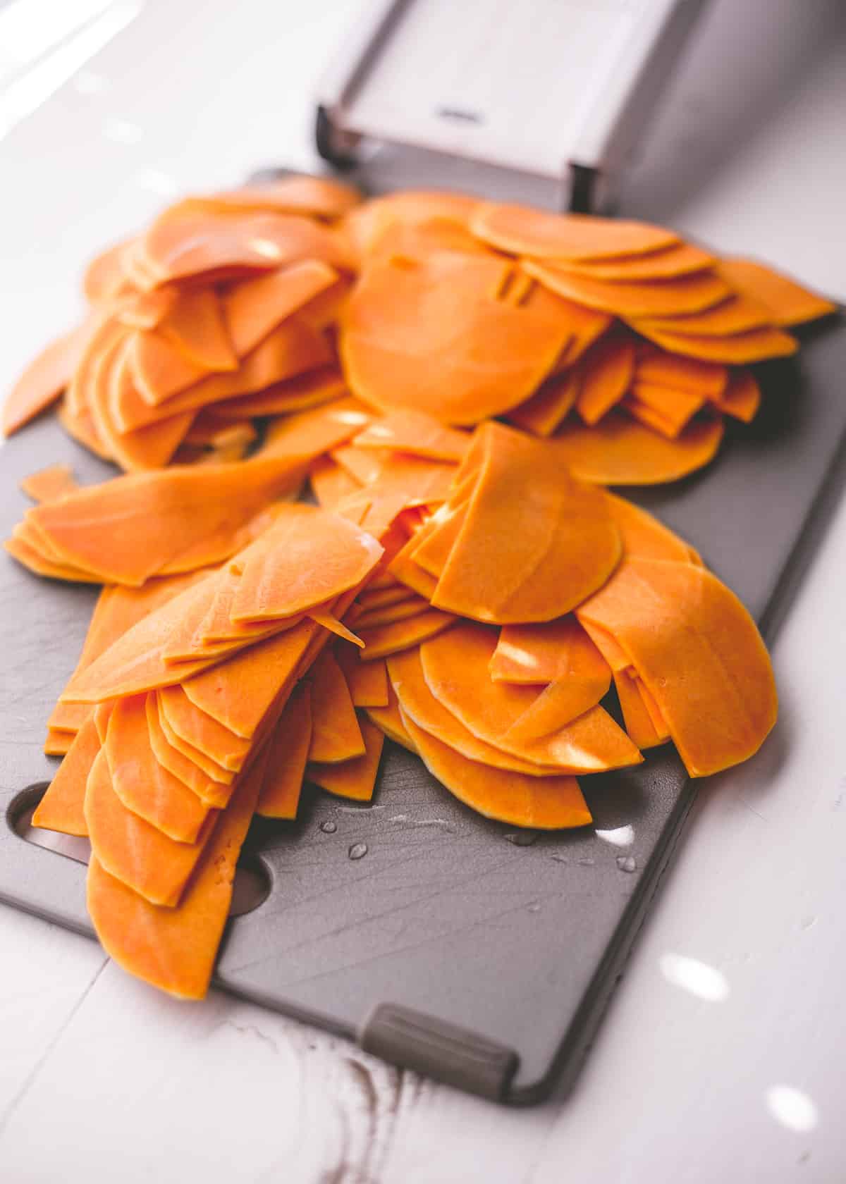 sliced squash on a grey cutting board