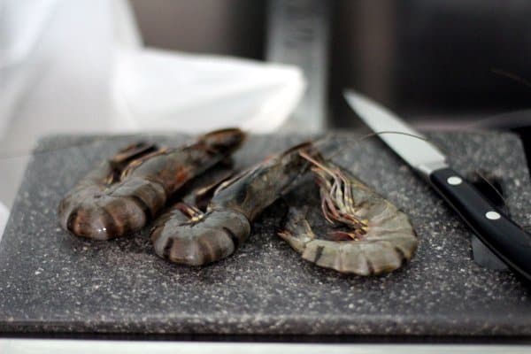 raw shrimp on a grey cutting board