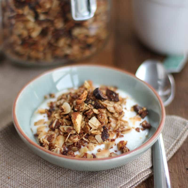 granola on top of yogurt in a blue bowl