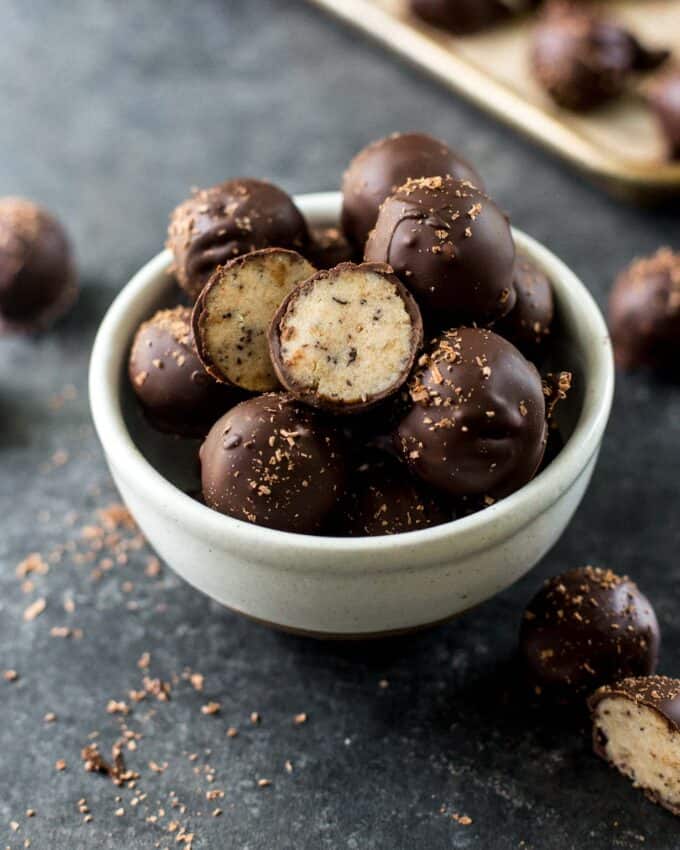 chocolate dipped banana bread truffles in a white bowl