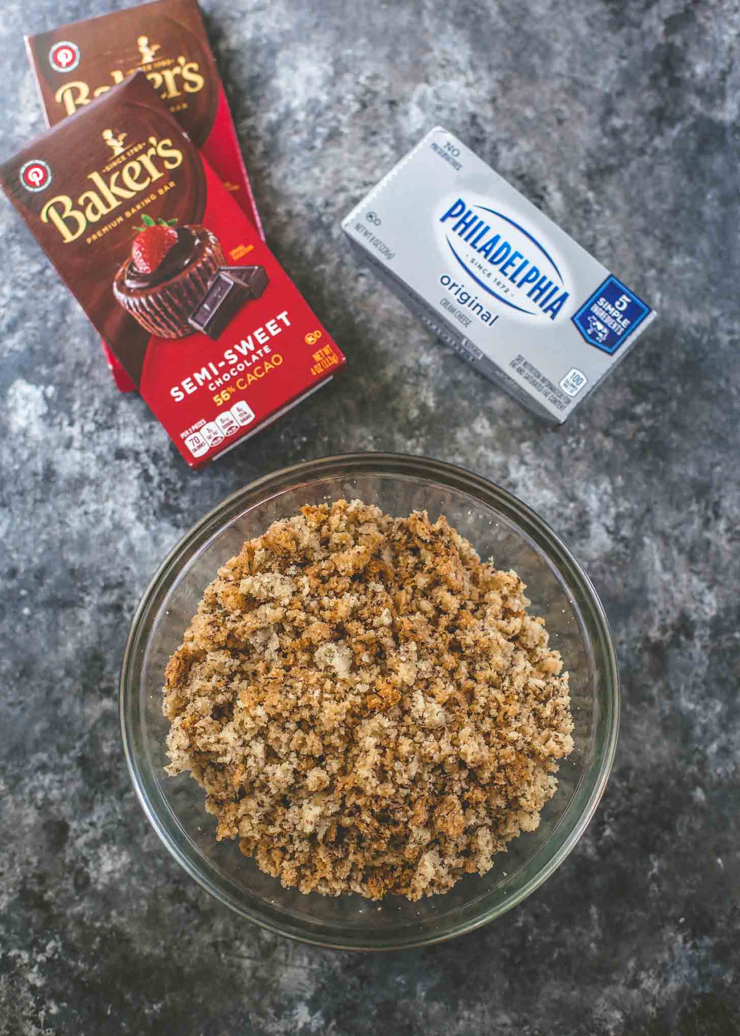 overhead image of chocolate, cream cheese and banana bread on a grey countertop