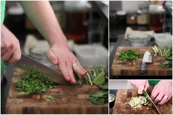 chopping herbs on a wooden cutting board