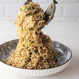 picking up miso noodles from a blue and white bowl