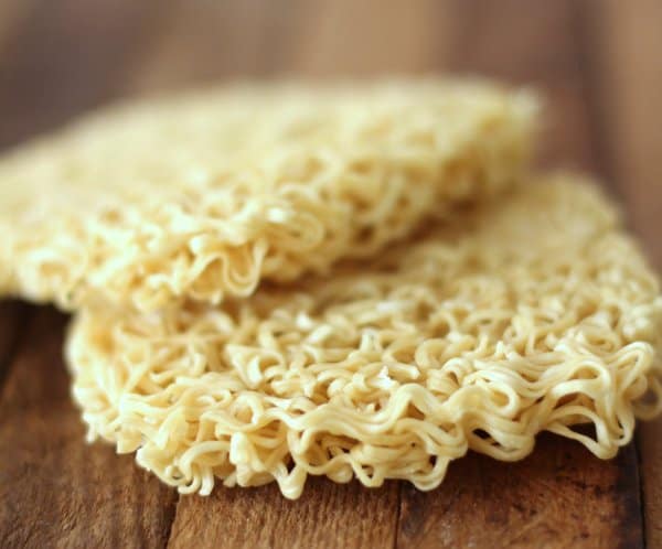 uncooked ramen noodles on a wooden tray