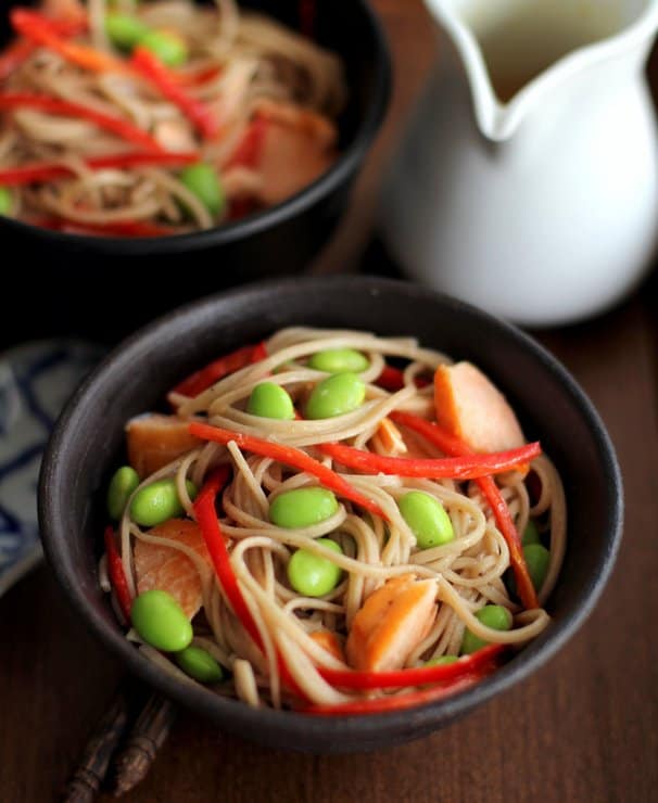 noodles and edamame in a black bowl