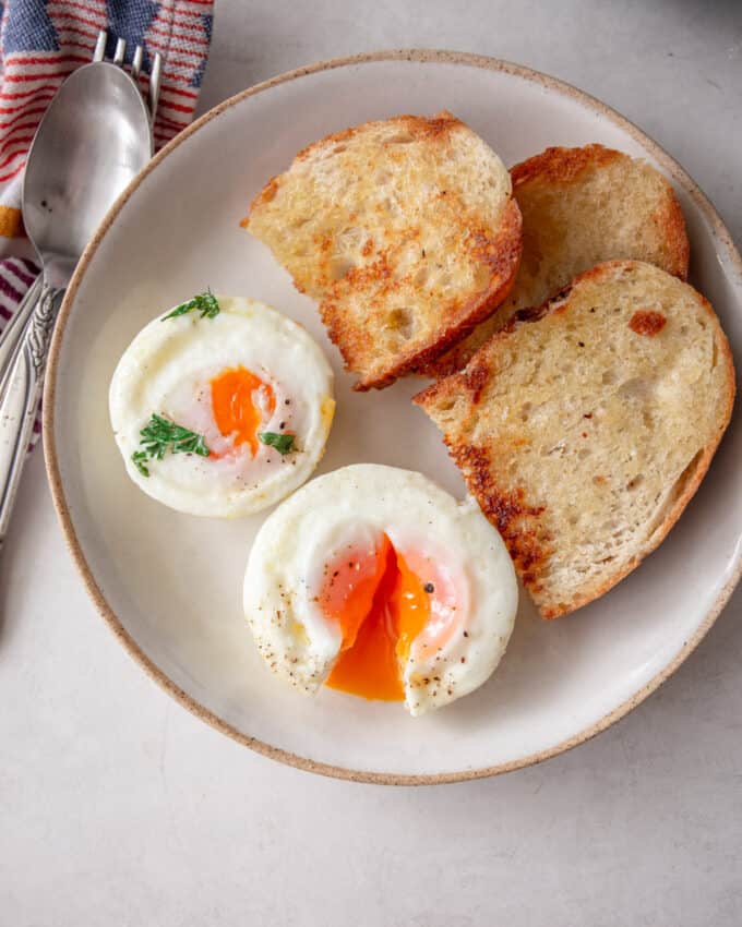 muffin pan baked eggs sliced open with toasted bread on the side_square