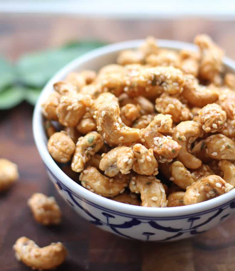 spicy cashews in a blue and white bowl