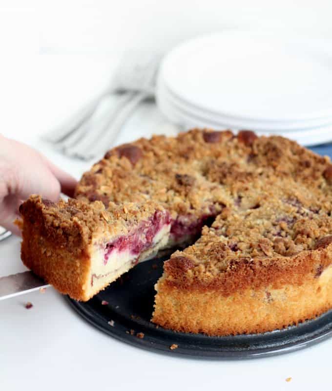 removing a slice of strawberry coffee cake