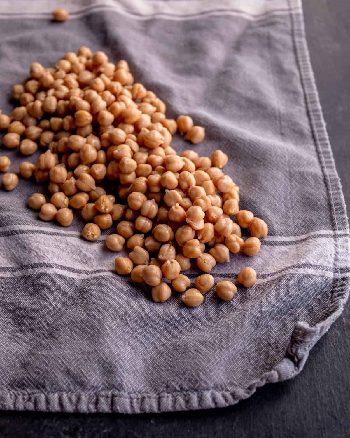 uncooked chickpeas on a gray dishtowel