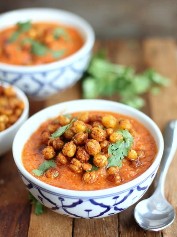 gazpacho in blue and white bowls, topped with crispy chickpeas