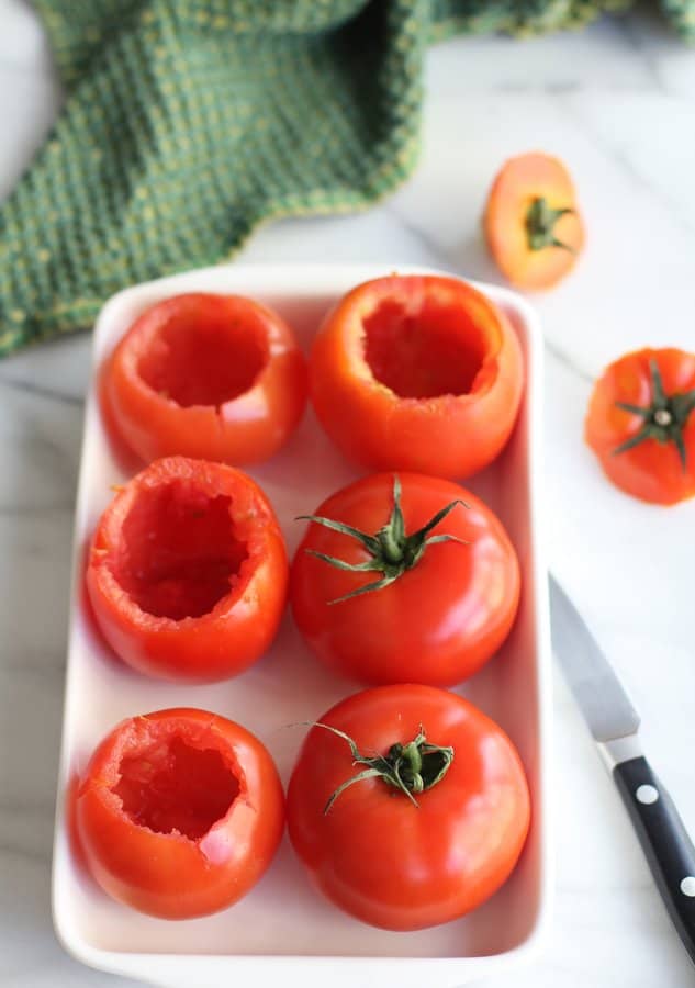 hollowed out tomatoes on a white tray