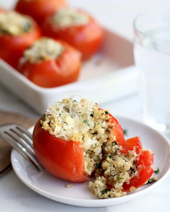 a stuffed tomato on a white plate