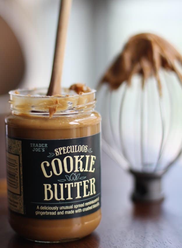 a wooden spoon in a jar of cookie butter