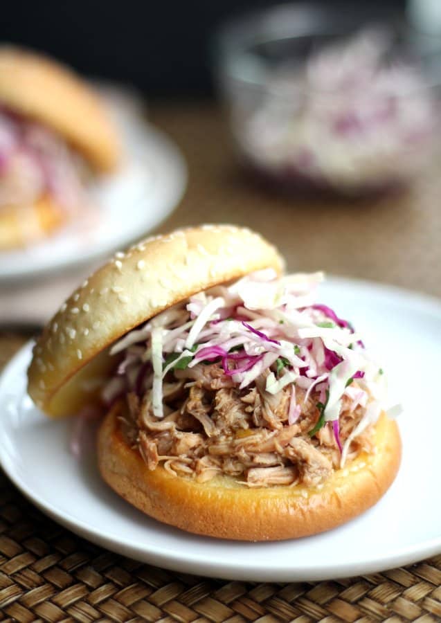 pulled chicken sandwich on a white plate