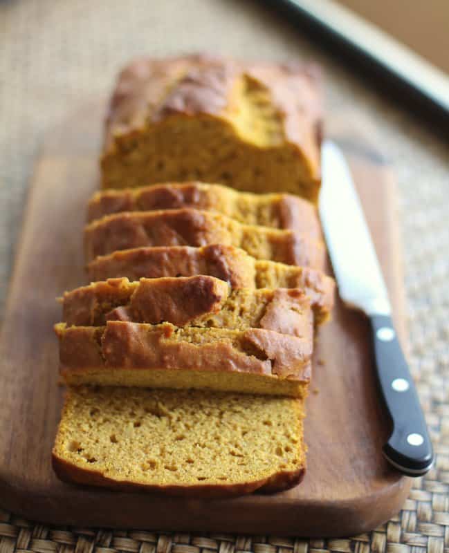 pumpkin cider bread sliced on a cutting board