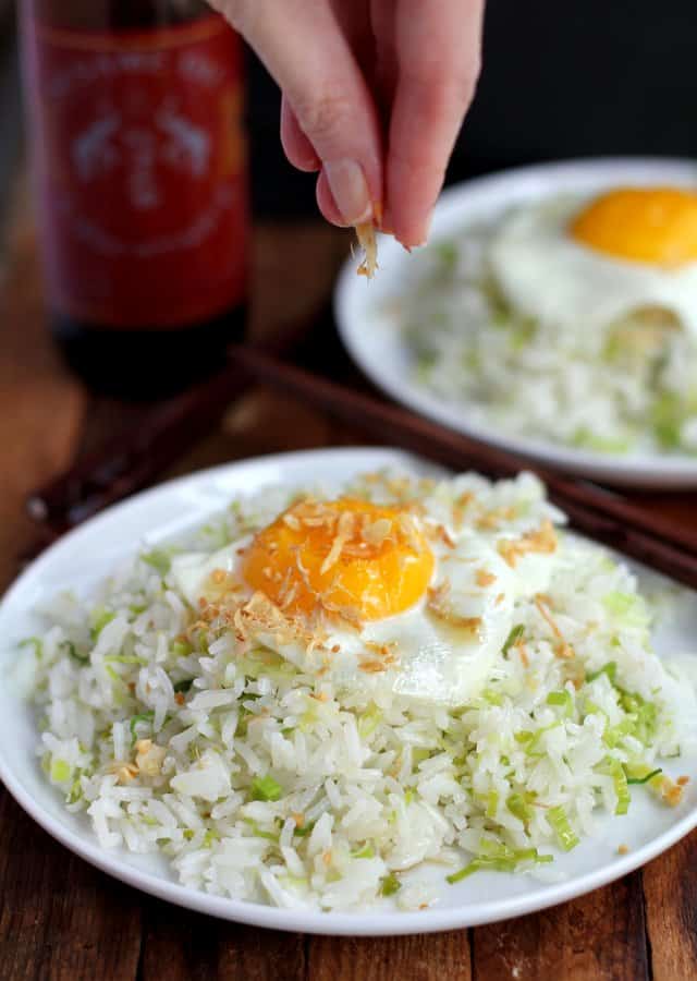 fried rice topped with a fried egg on a white plate